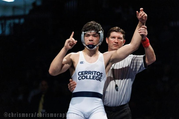 Referee upholding Armando Murillo's arm announcing victory