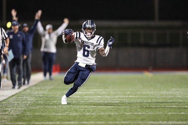 Davon Booth running in the field