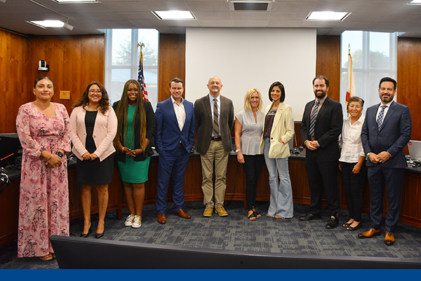 Cosmetology team with the board