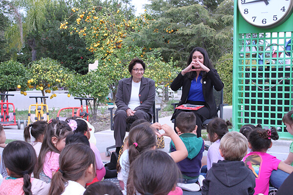 Mariana and Blanca Pacheco reading to the CDC children