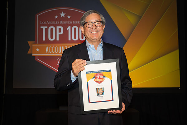 Charles Osaki with the award