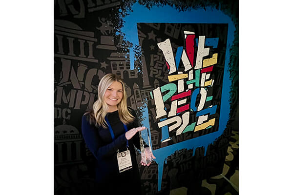 Chelsea Van Doornum holding the award plaque