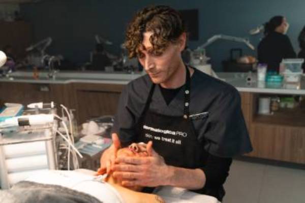 Student performing a facial on a client