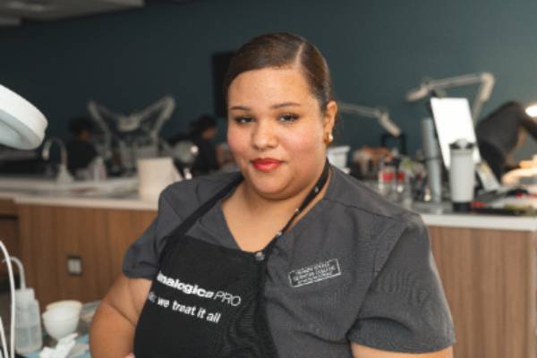 Student posing in an esthetician classroom environment.