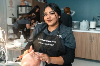 Student performing facial on a client