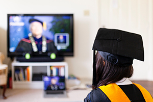 Graduation student watching online graduation service