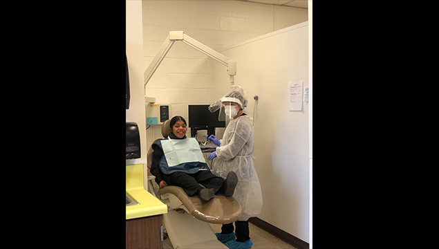 Dental student preparing to work with patient