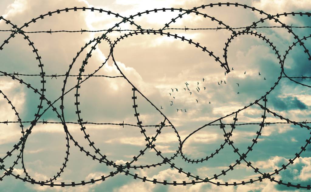 Barbed wire fence containing heart shape