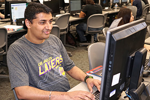 Male international student in a computer lab