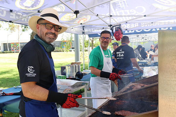 Dr. Fierro and Felipe Lopez grilling meat