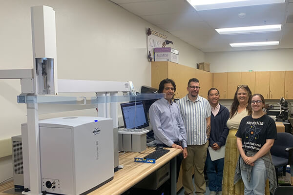 Faculty and staff with the new NMR spectrometer
