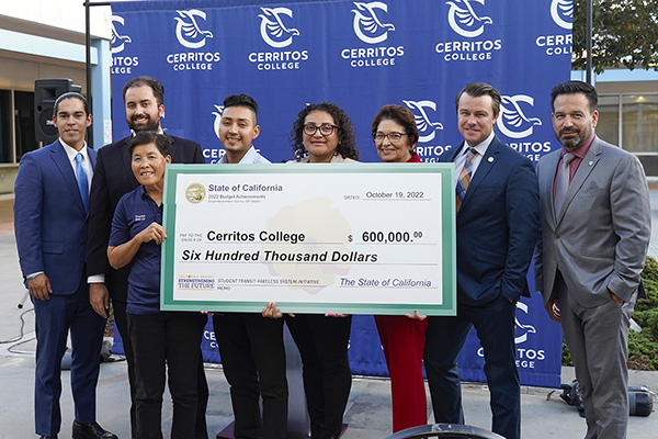 Asm. Garcia's rep and the College officials holding a large check