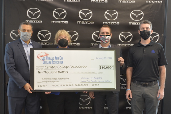 Nazi Yehya, Carol Krumbach, Mat Browning, and Joe Mulleary (l-r) with a check
