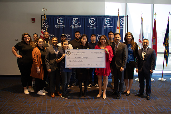 Rep. Michelle Steel, student veterans, and college officials holding a check