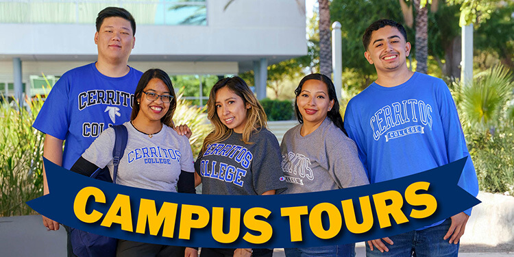 Fine Arts Building Students smiling with a sign in front of them that says "Campus Tours"