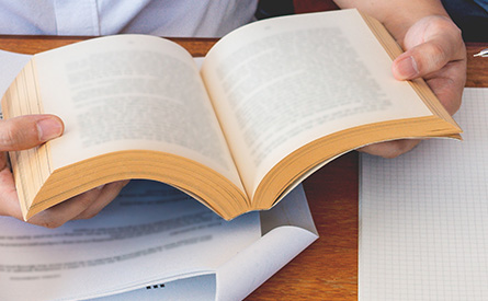 hands holding an open book
