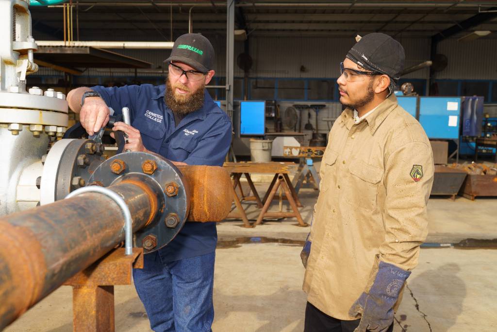 two individuals welding